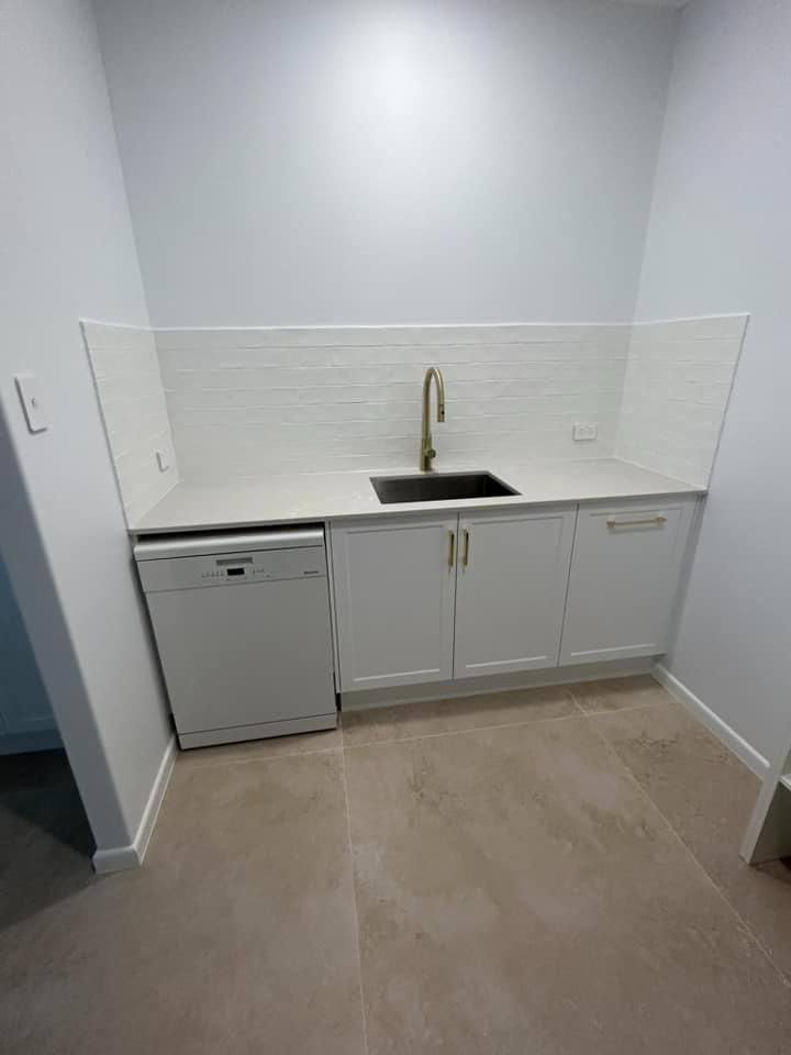 A Kitchen with White Cabinets, a Sink, and A Dishwasher — Formosa Building And Renovations in Bargara, QLD