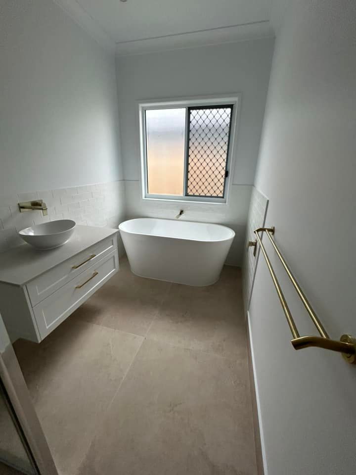 Renovated Bathroom with White Sink — Builders in Kensington, QLD