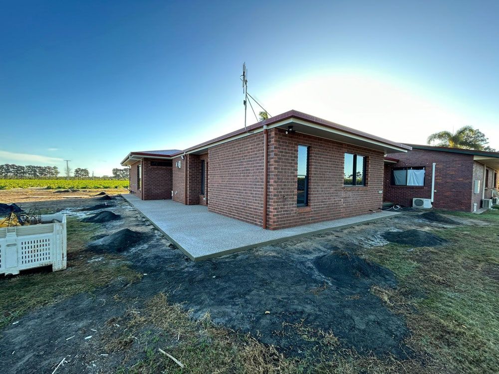 Brown Brick House In Open Area — Builders in Kensington, QLD