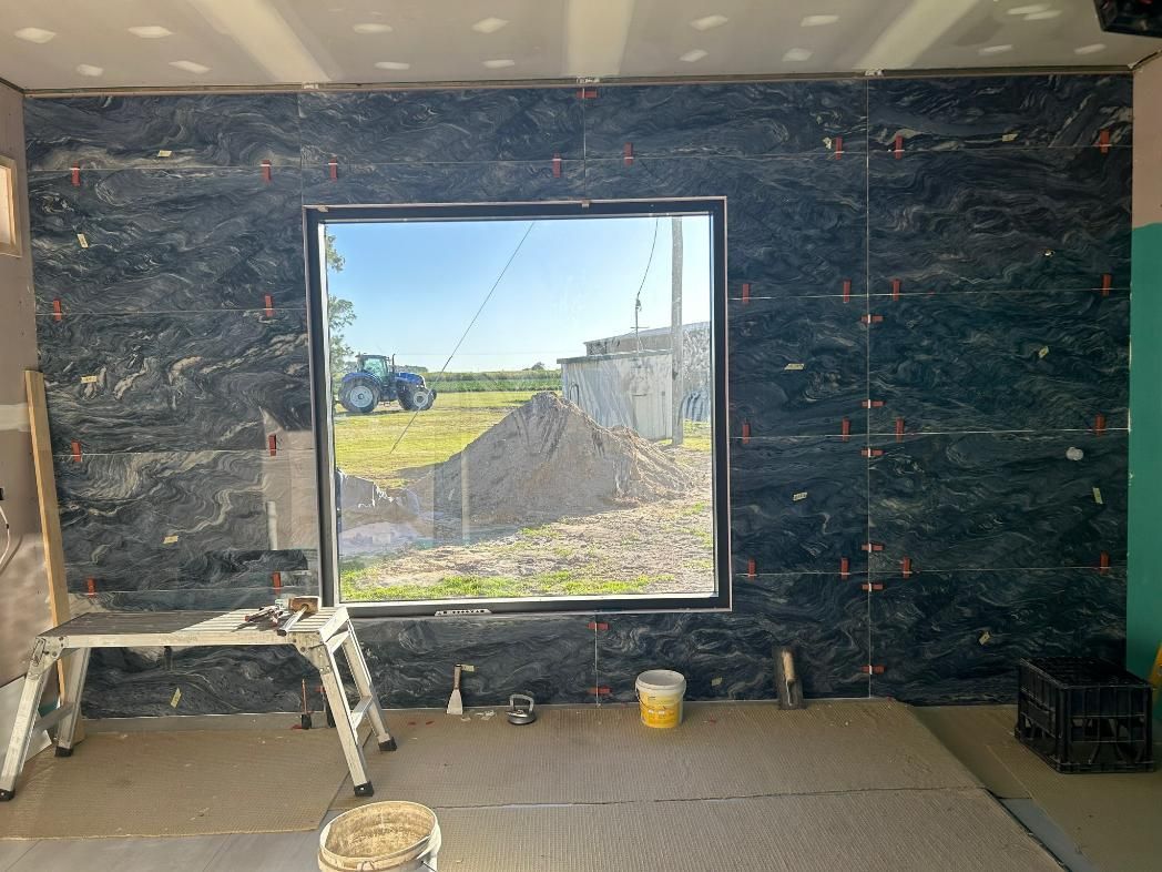 A Room with A Large Window and A Tractor in The Background — Formosa Building And Renovations in Childers, QLD