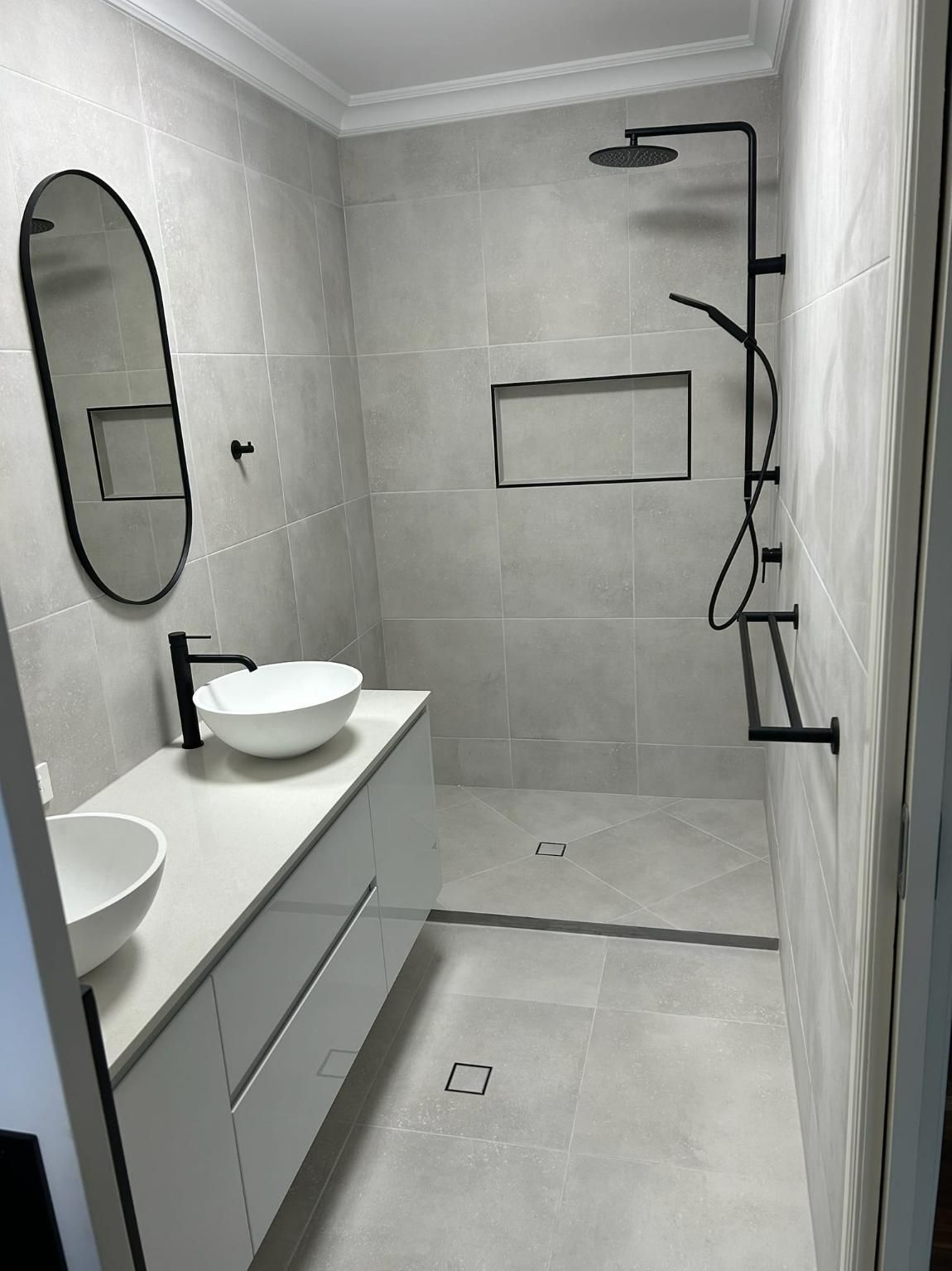 A Bathroom with Two Sinks, A Shower and A Mirror — Formosa Building And Renovations in Bundaberg, QLD