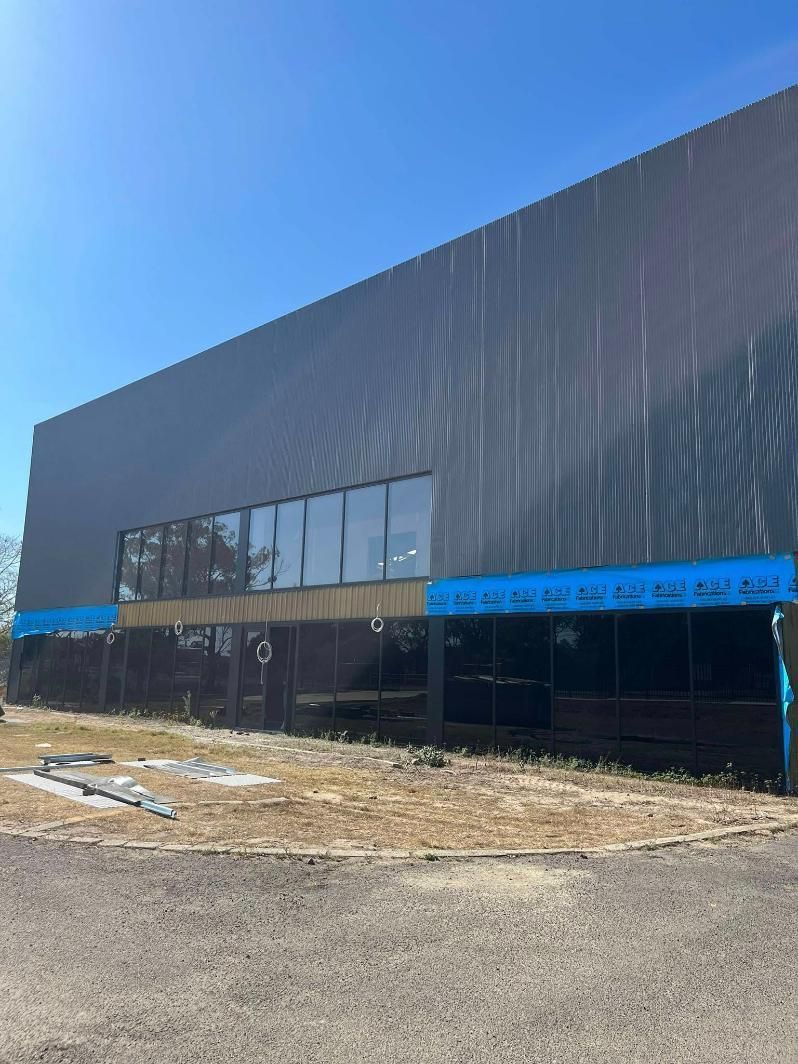 A Large Building with A Lot of Windows Is Being Built — Formosa Building And Renovations in Bundaberg, QLD