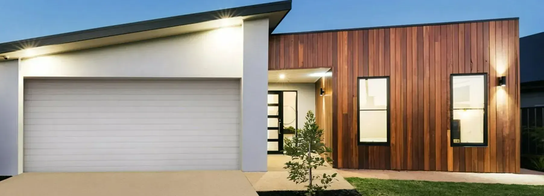 Modern House Exterior Featuring a Garage — Duncan's Doors In Kearneys Spring, QLD