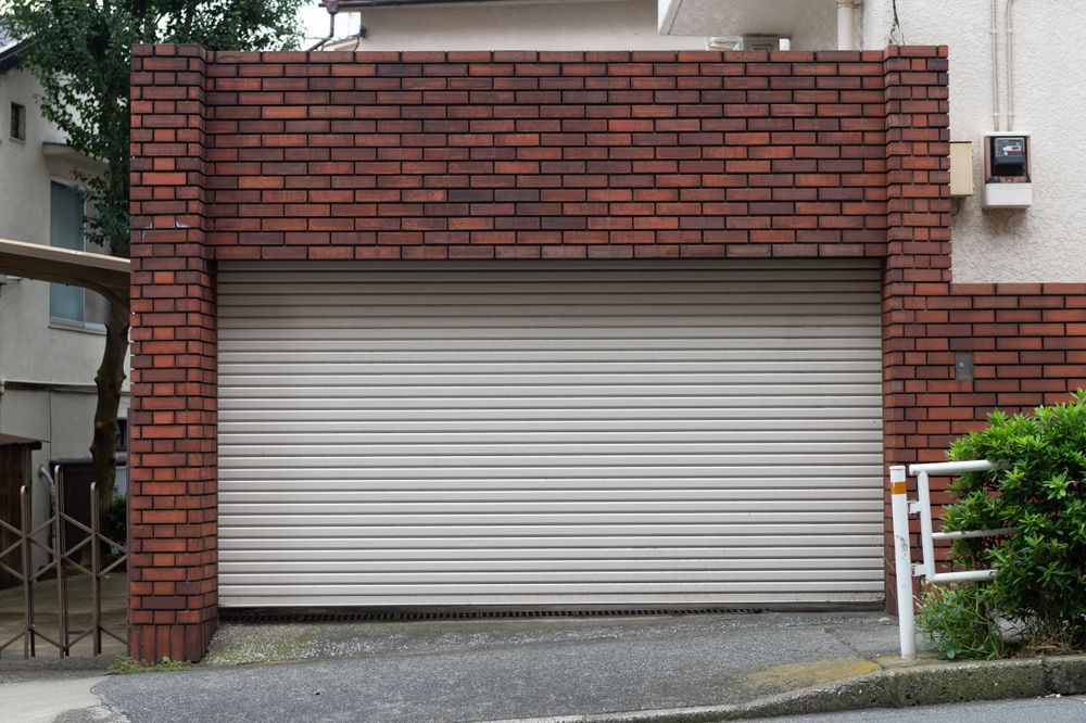 Garage With Brick Facade and Closed, Light-colored Rolling Door — Duncan's Doors In Crows Nest, QLD