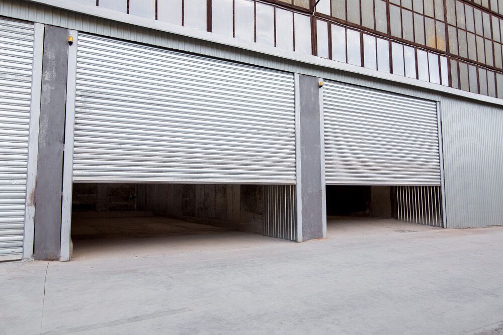 Rolling Metal Garage Doors Partially Open — Duncan's Doors In Oakey, QLD