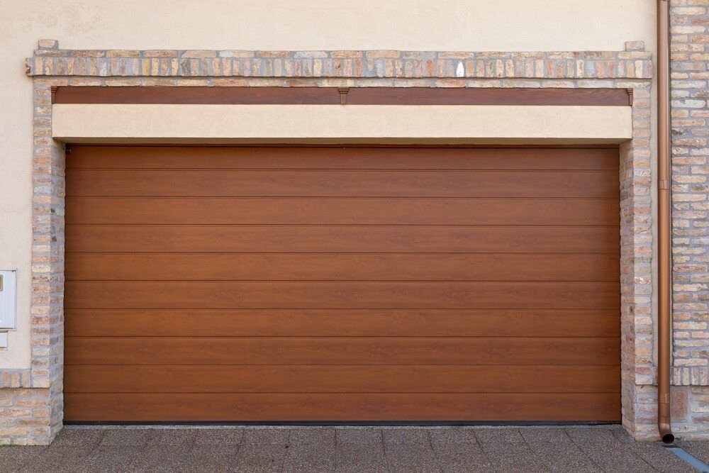 Brown Wooden Garage Door With a Brick Frame — Duncan's Doors In Warwick, QLD