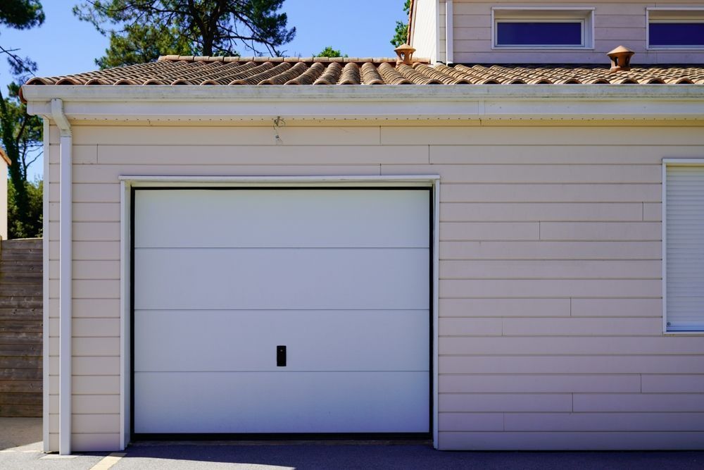 White Garage Door on a Light-colored Building — Duncan's Doors In Dalby, QLD
