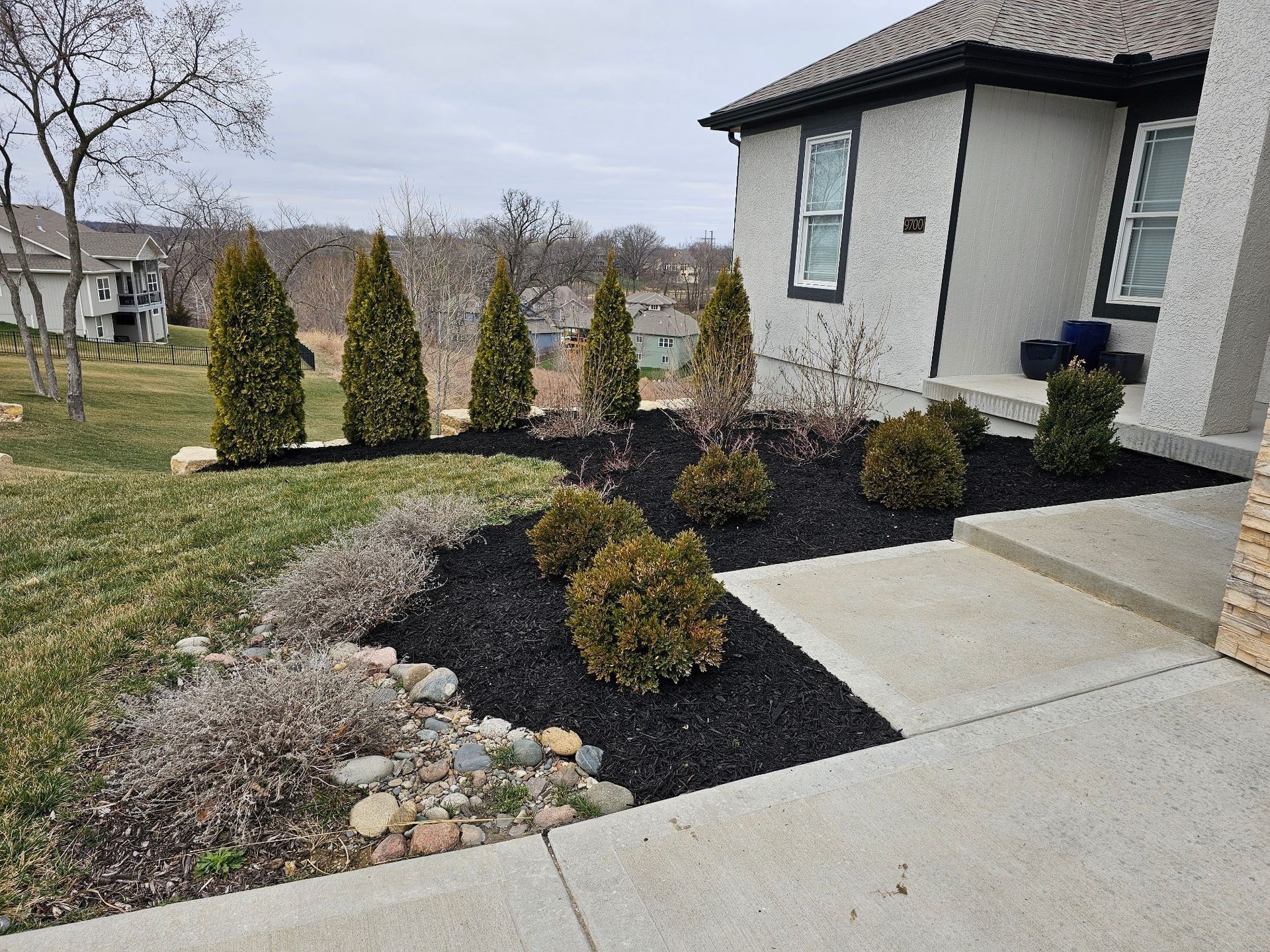 Rock, mulch, and plant bed maintenance performed by professional landscapers