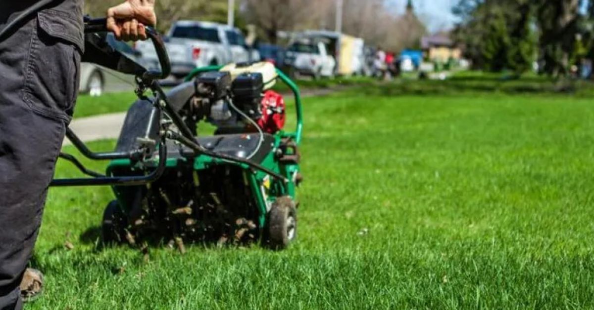 A worker preparing for Core aeration lawn service in Gladstone, MO by Lawnscape Specialists