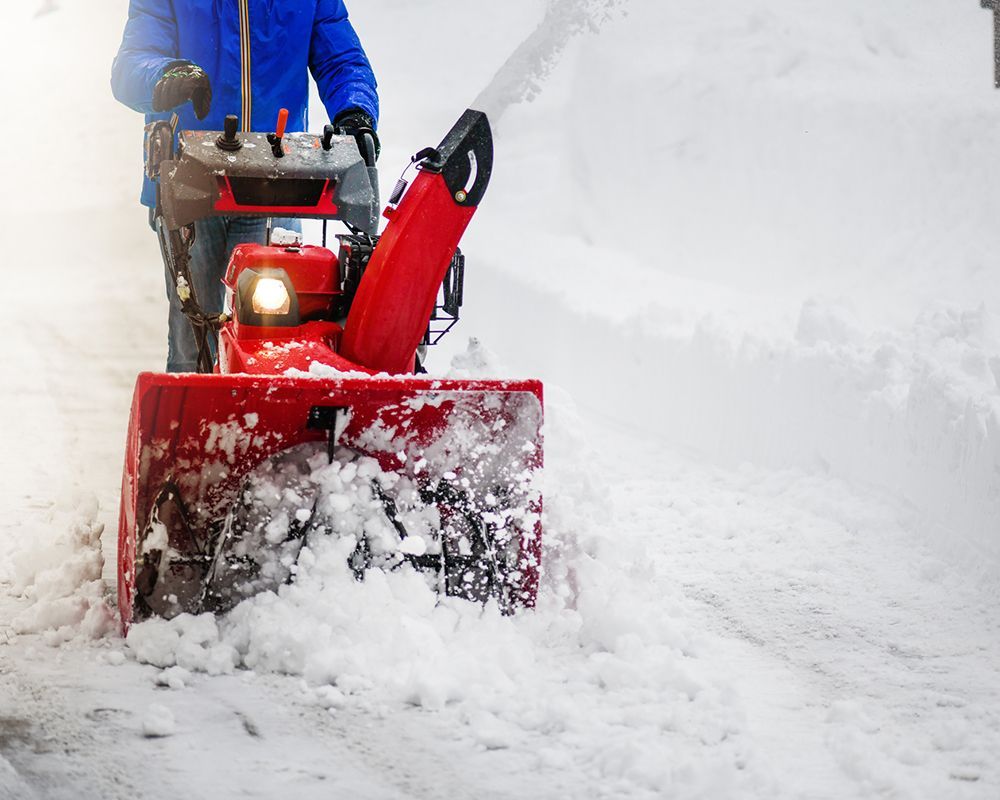 Worker Using a Snow Blower — Des Moines, IA — Timberline Tree Service