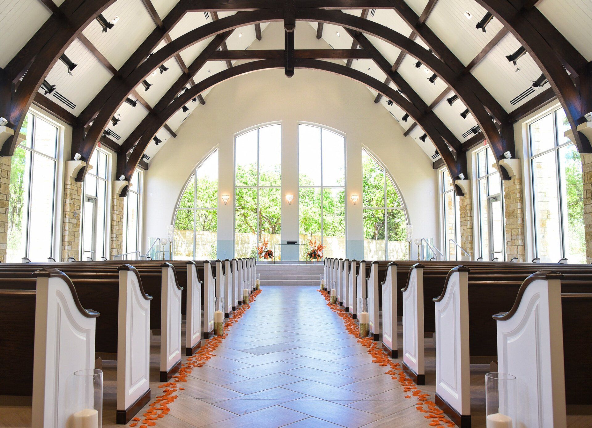 the inside of a church with rows of white pews
