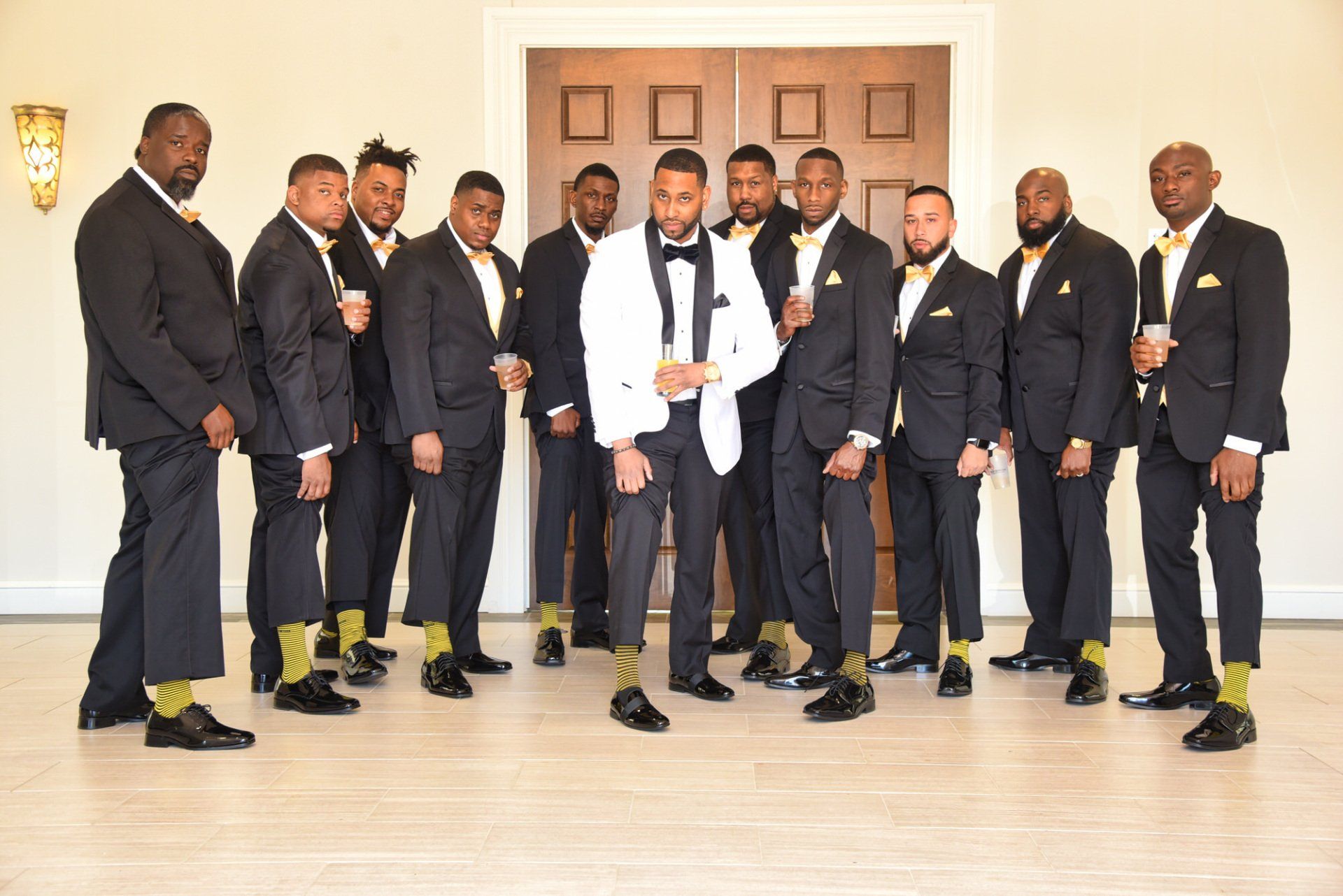 a group of men in suits and socks are posing for a picture .