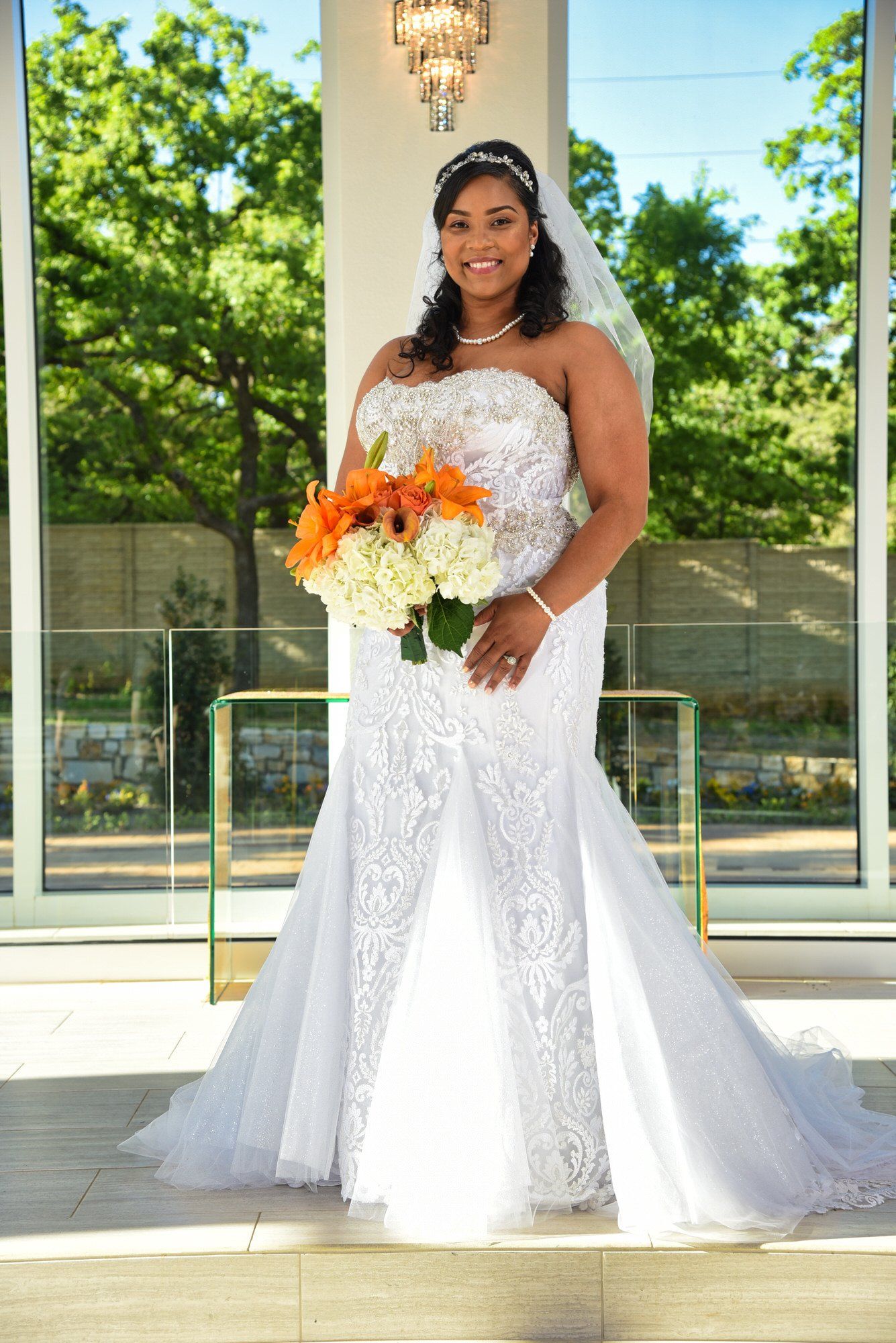 a woman in a wedding dress is holding a bouquet of flowers