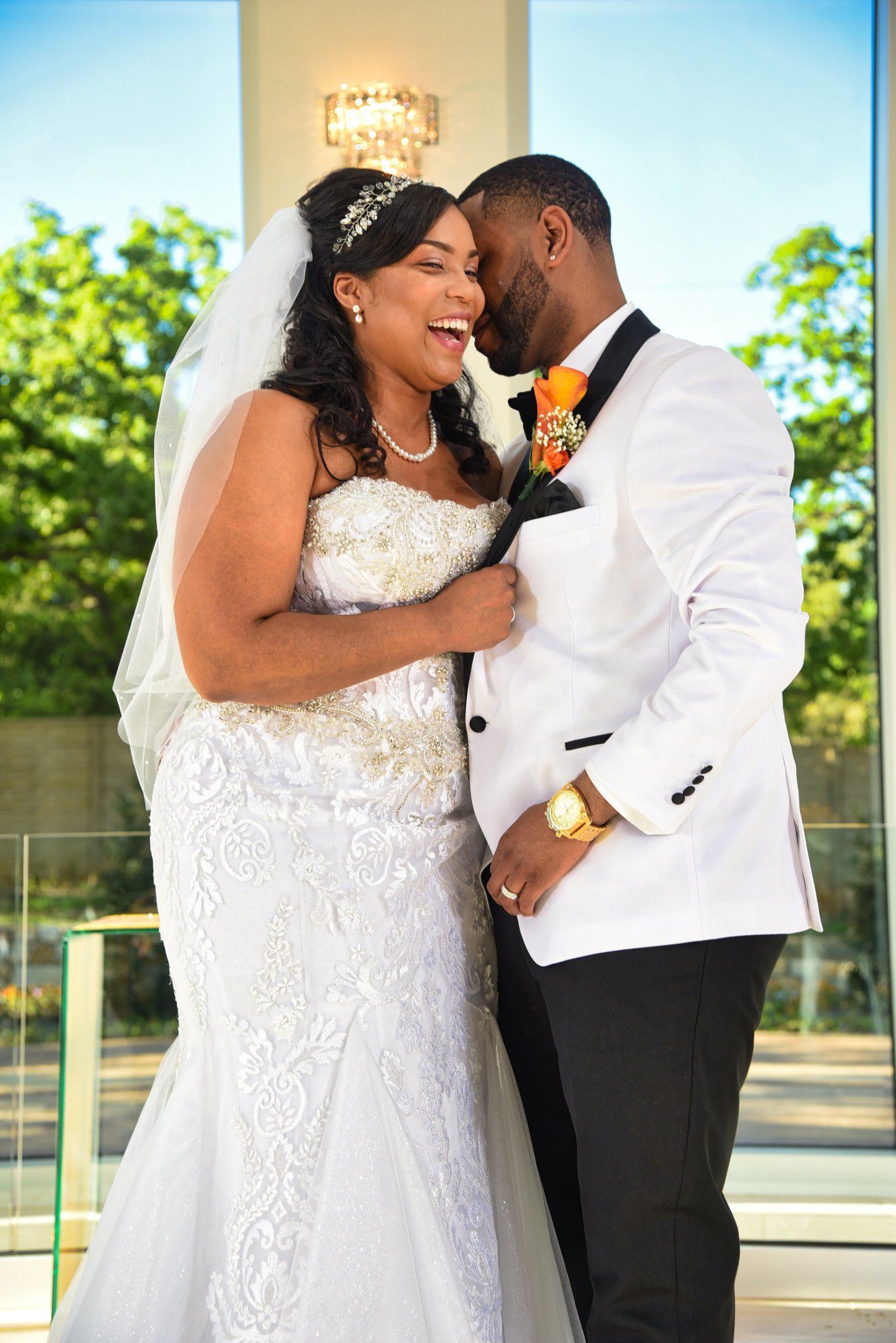 a bride and groom are posing for a picture on their wedding day .