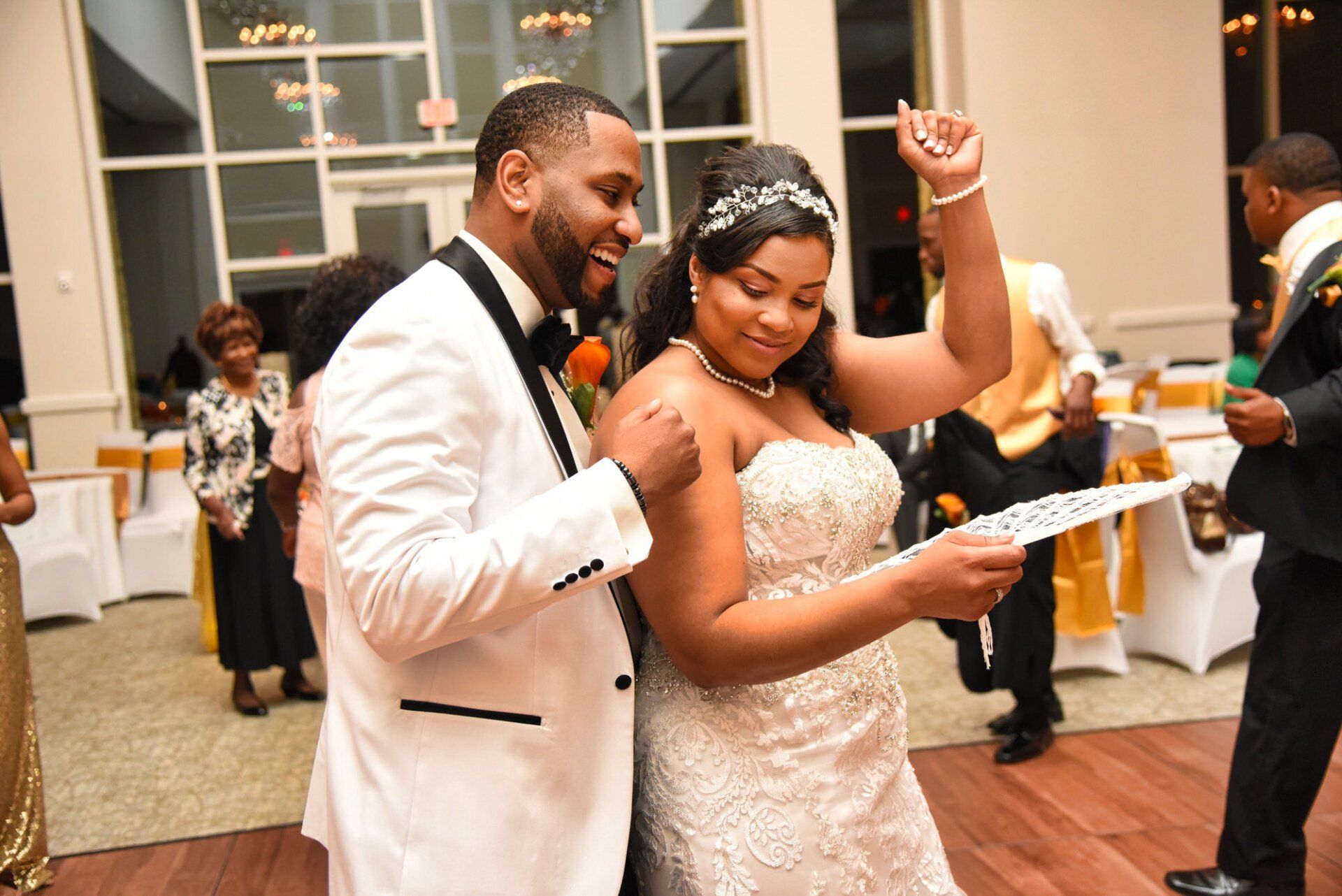 a bride and groom are dancing at their wedding reception .