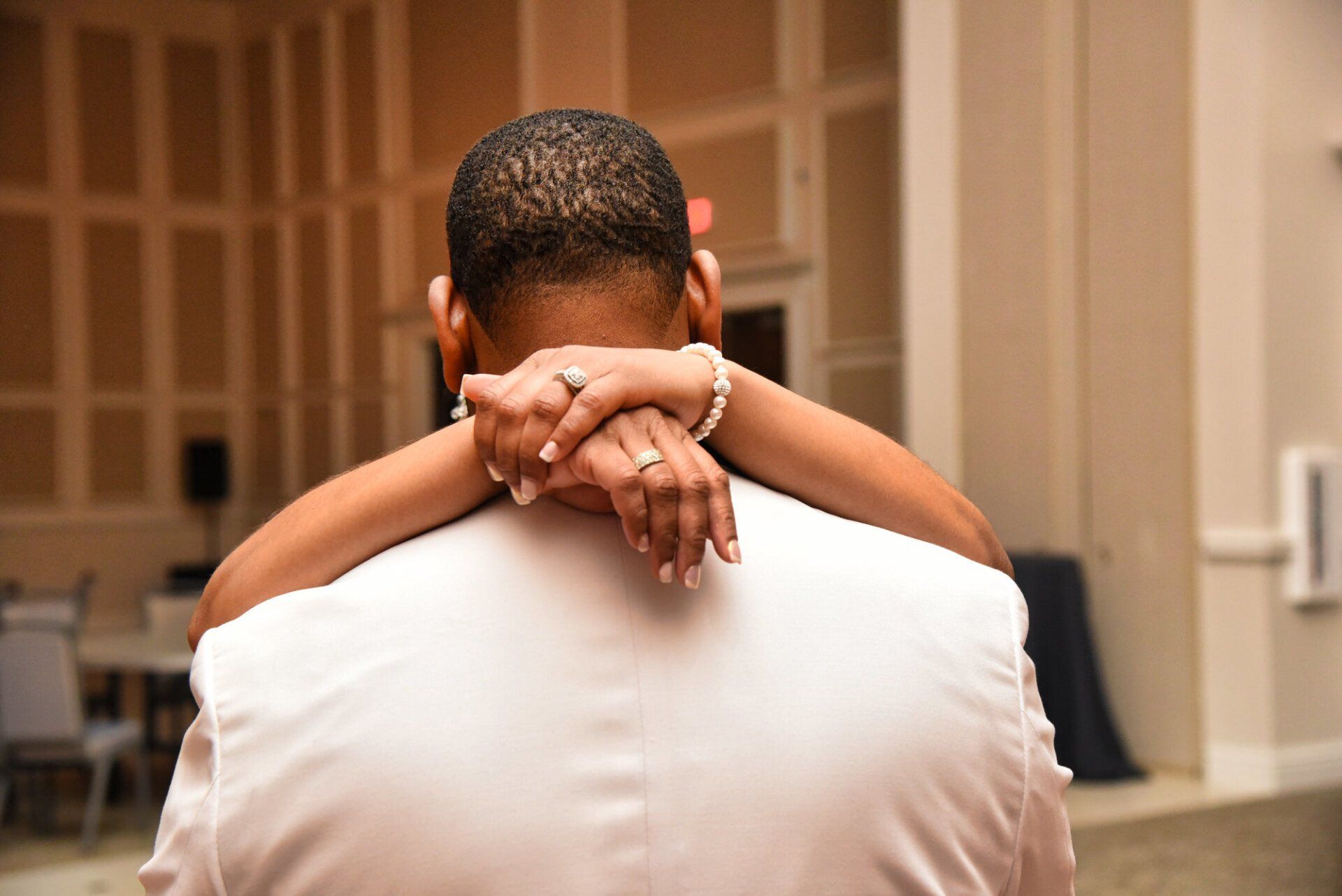 a bride and groom are dancing together at their wedding reception .
