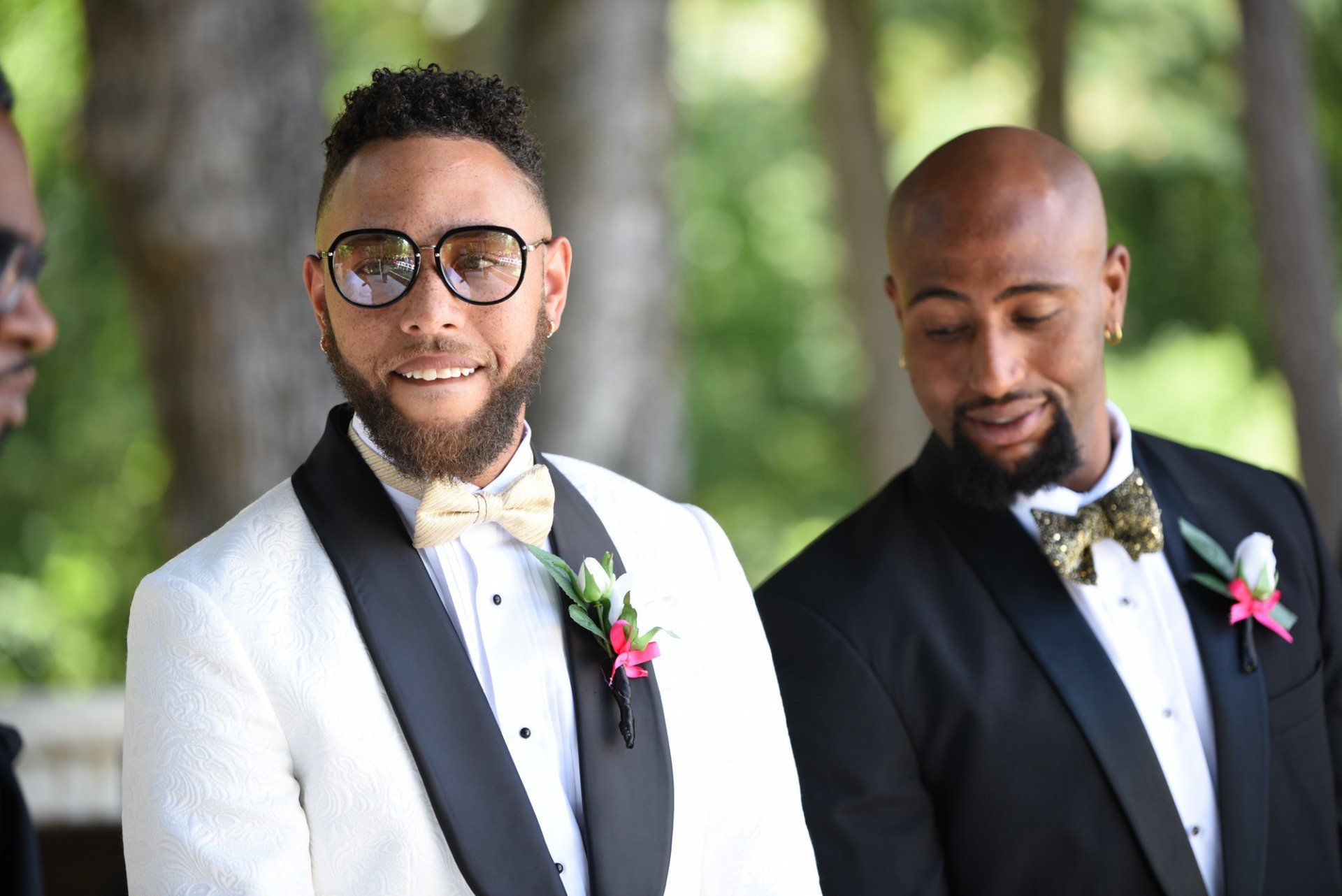 two men in tuxedos and bow ties are standing next to each other .