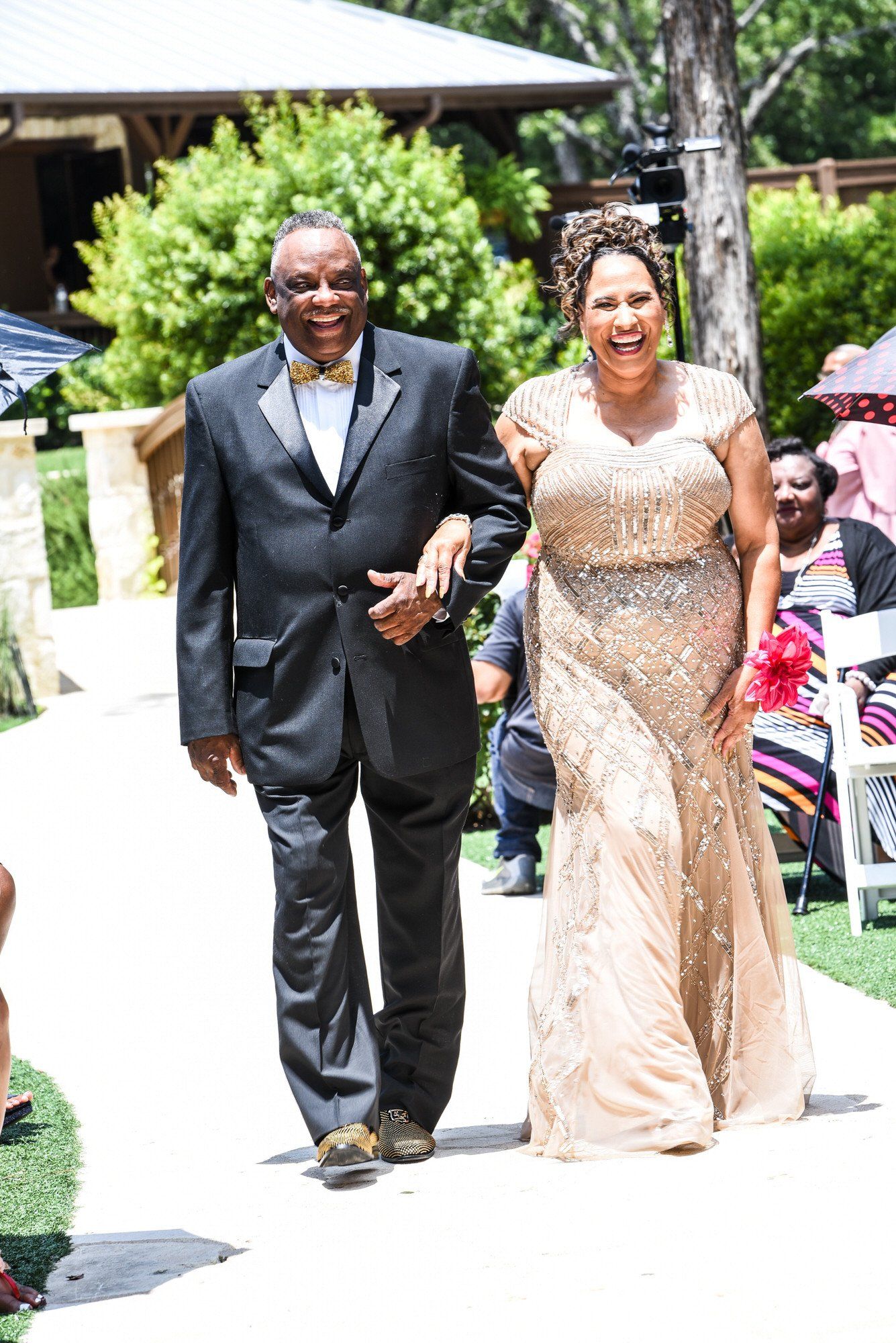 a man and woman are walking down the aisle at a wedding .