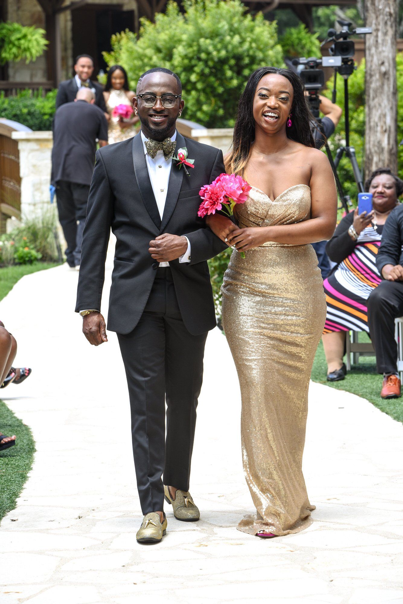 a bride and groom are walking down the aisle at their wedding .