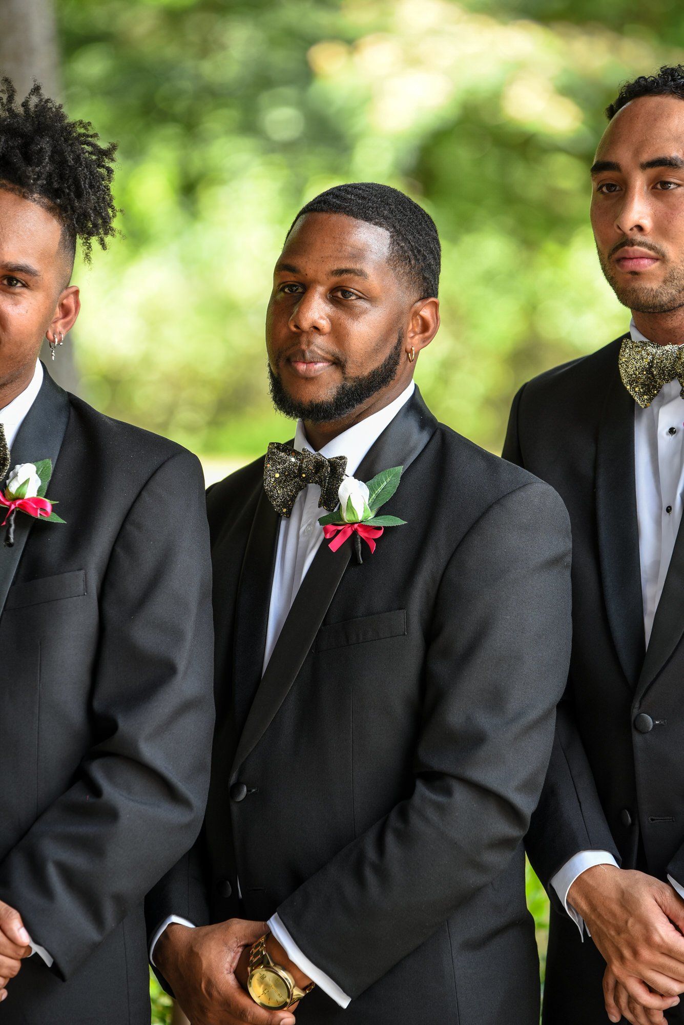 three men in suits and bow ties are standing next to each other .