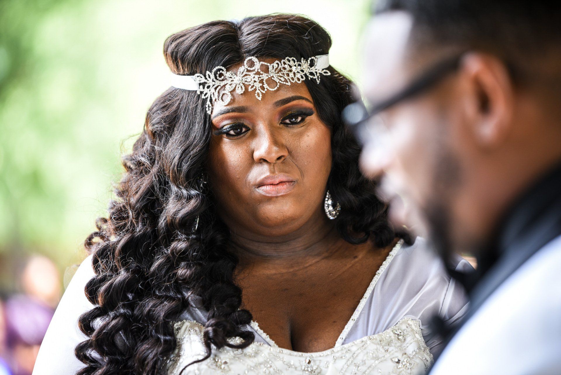 a woman in a wedding dress is looking at a man in a suit .