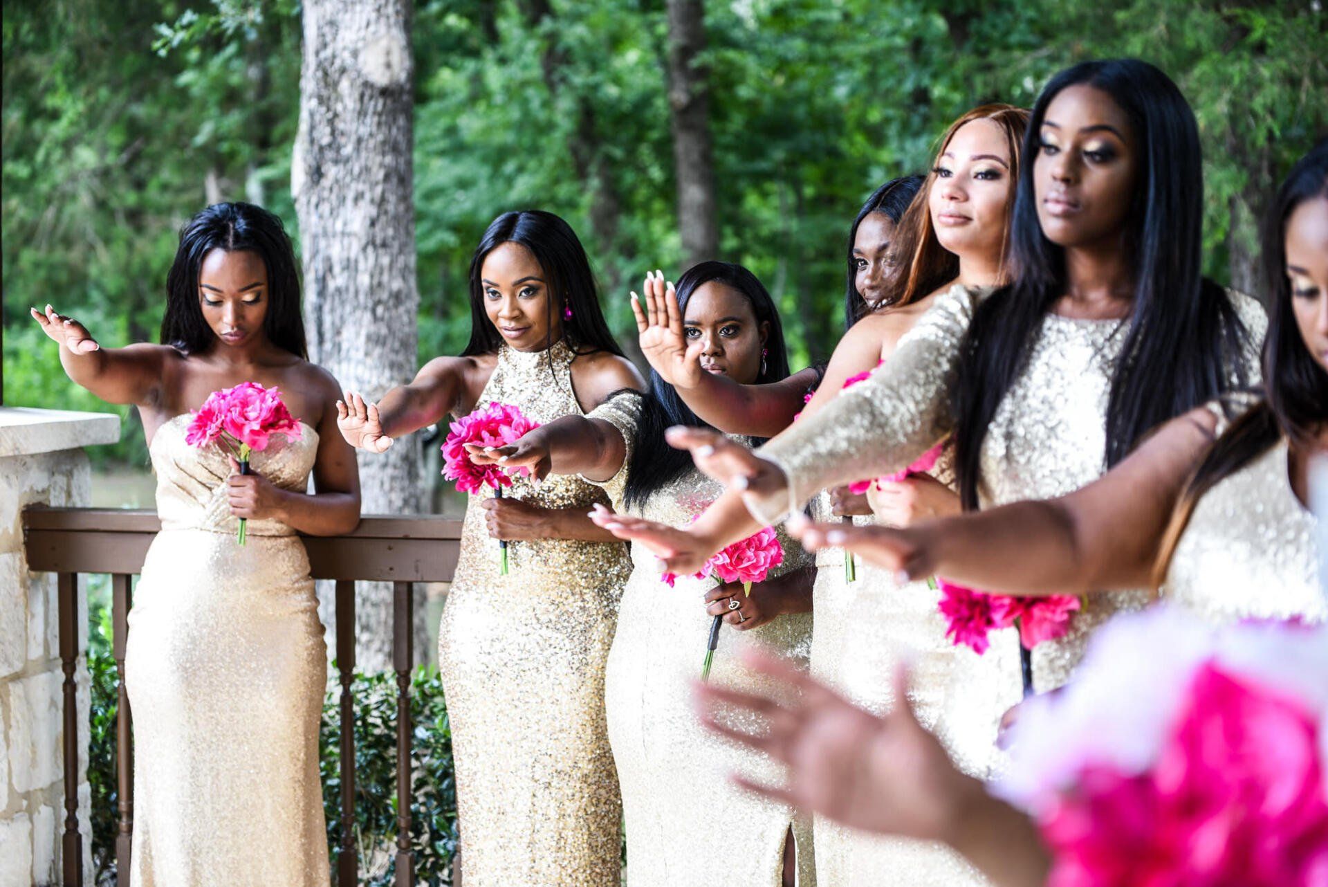 a group of bridesmaids are standing next to each other on a balcony .