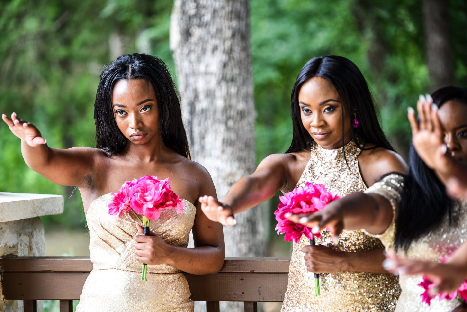 a group of bridesmaids standing next to each other holding bouquets of pink flowers .