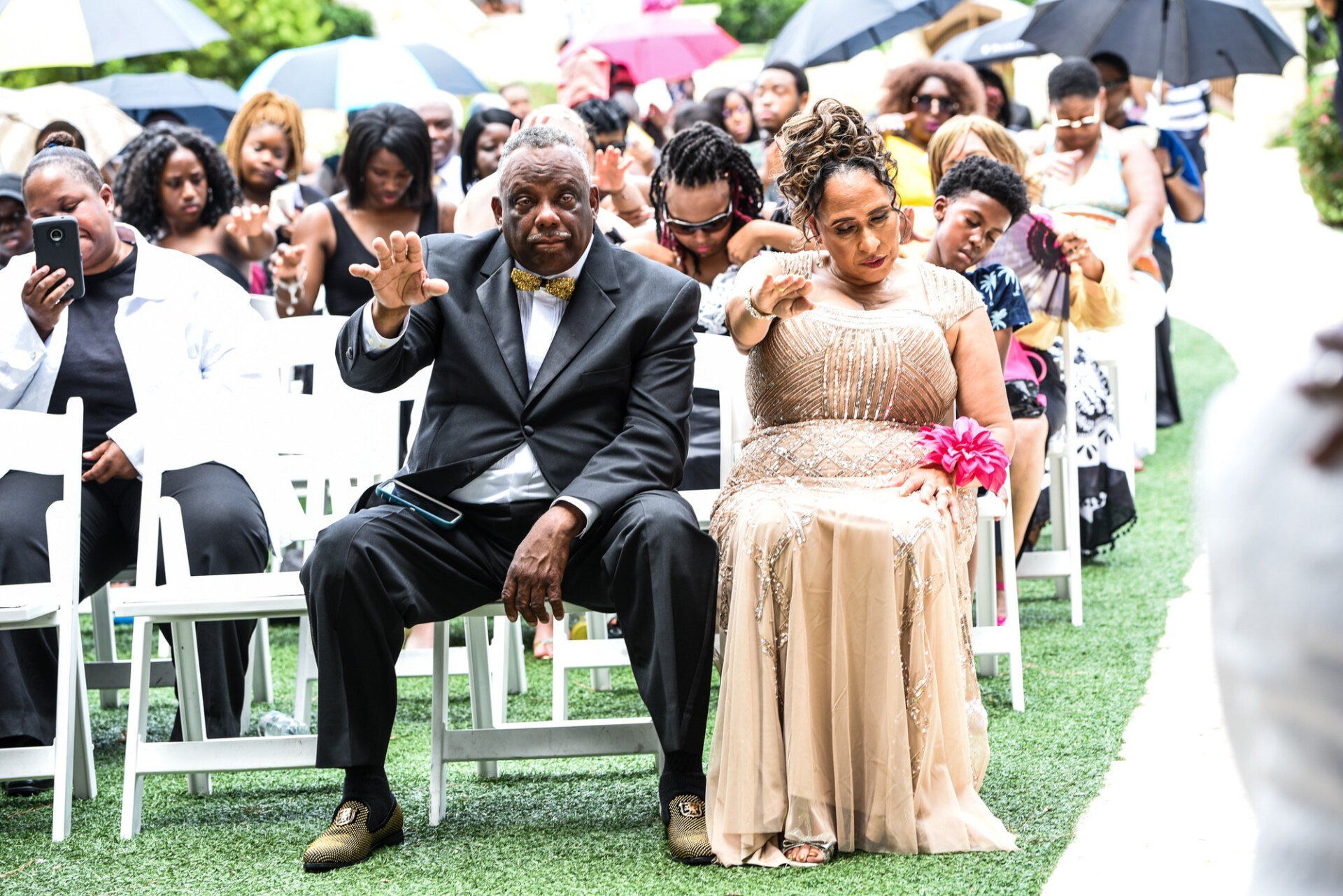 a bride and groom are sitting in chairs during a wedding ceremony .
