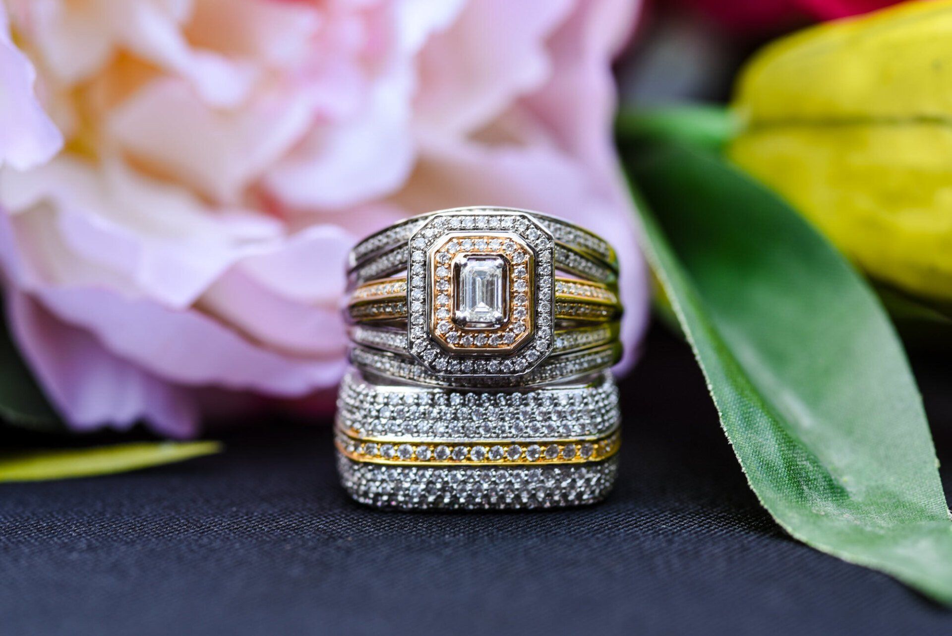 a close up of a wedding ring sitting on top of a flower .