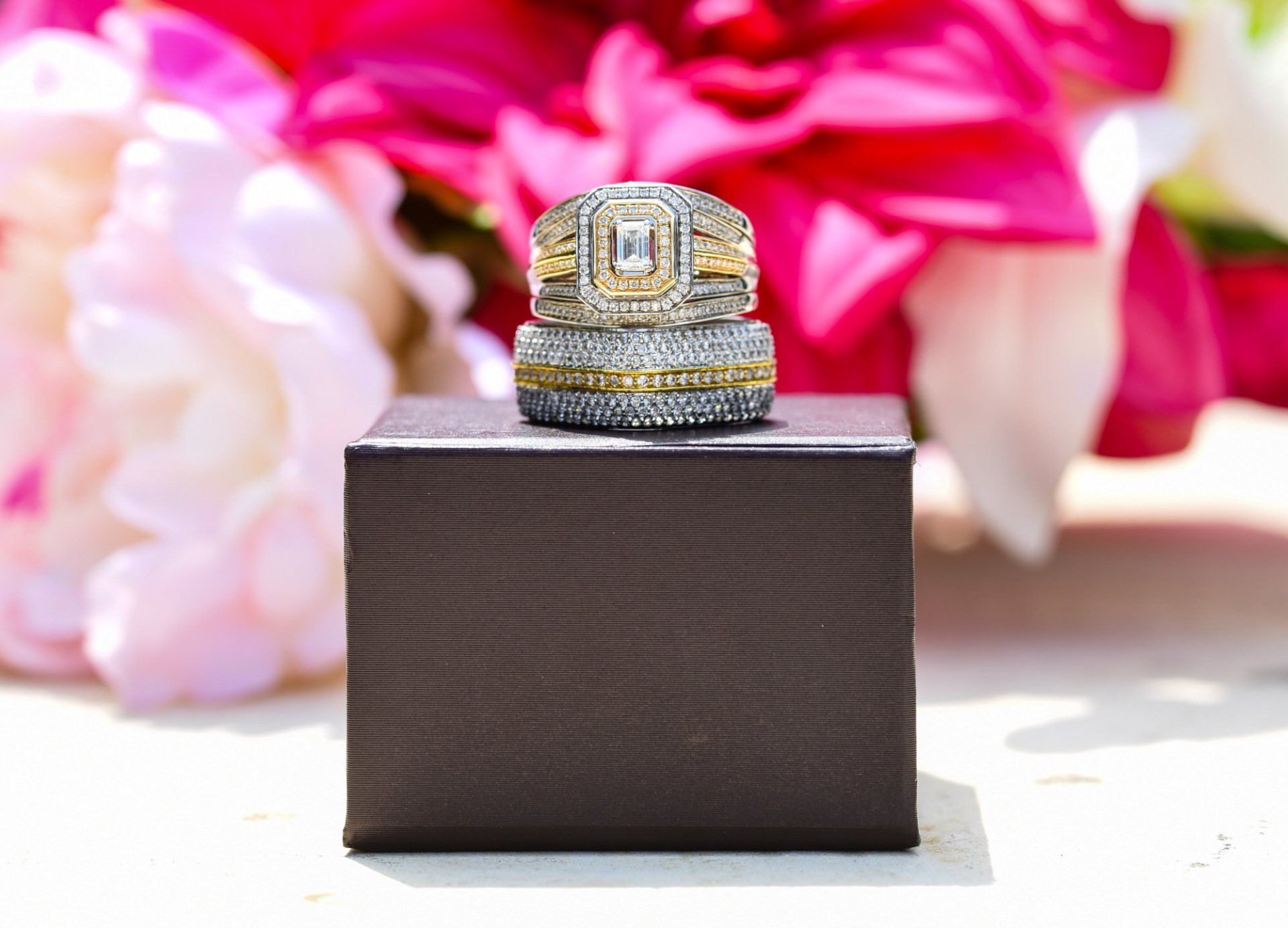 a couple of wedding rings sitting on top of a box