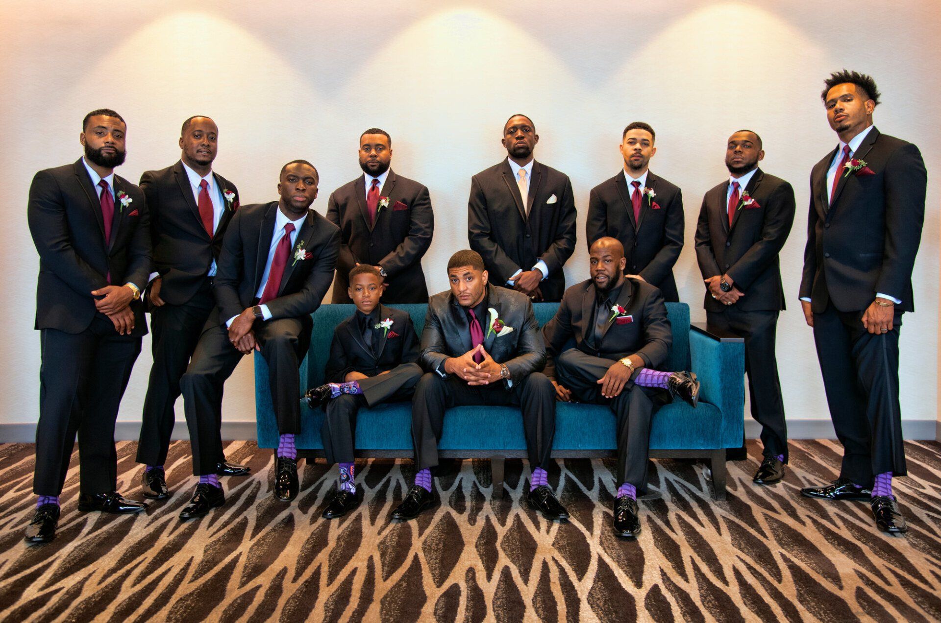 a group of men in suits and ties are posing for a picture .