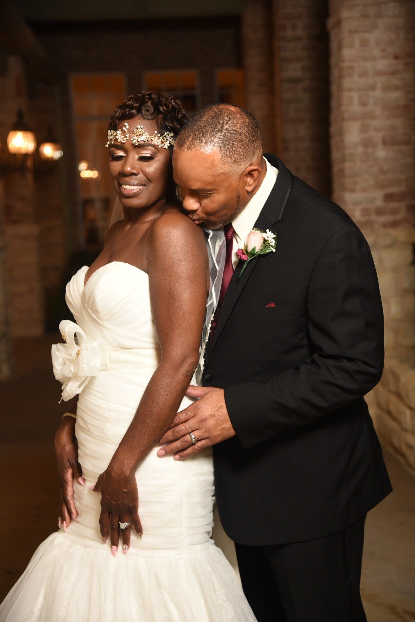 a bride and groom are posing for a picture on their wedding day .