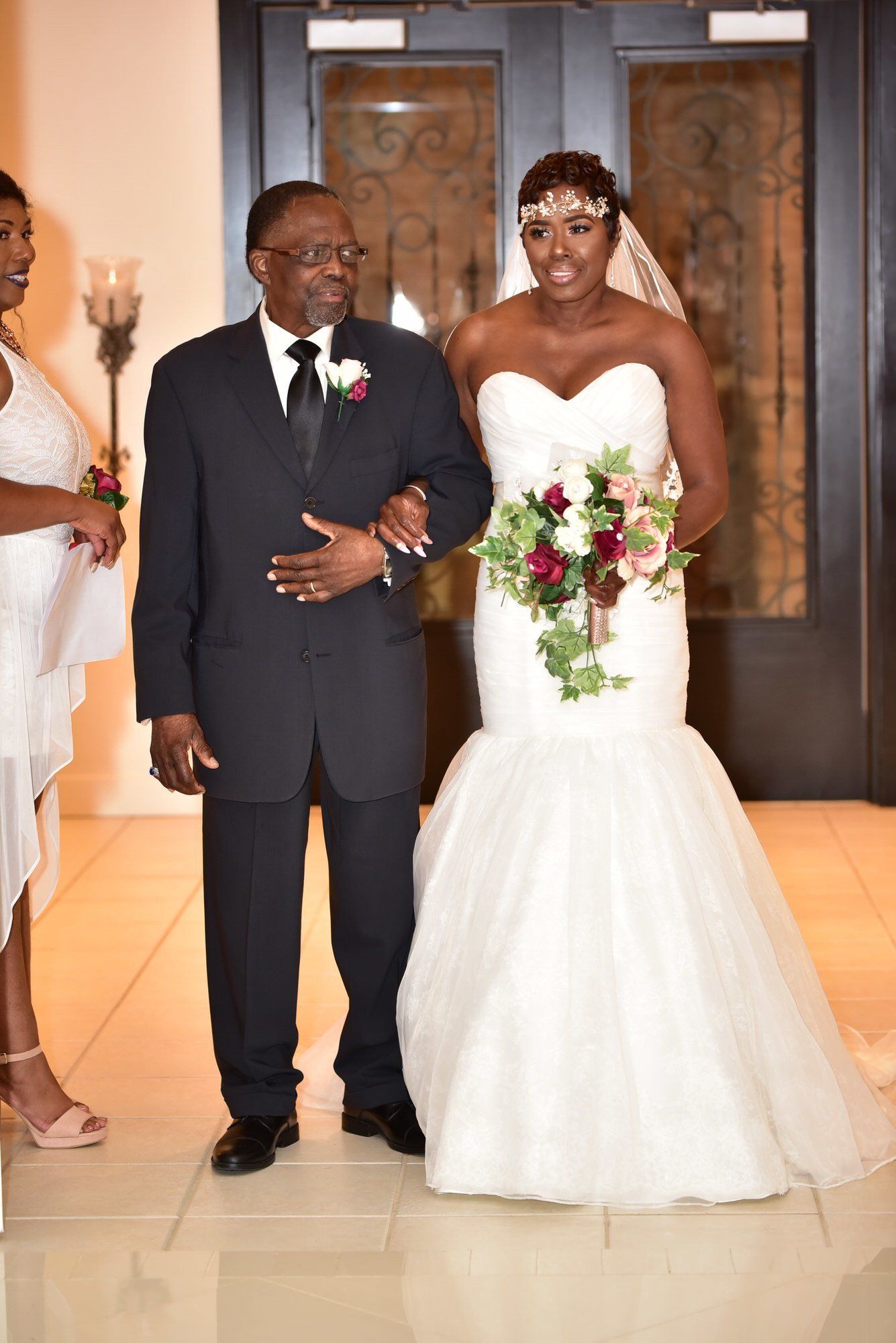 a bride is walking down the aisle with her father .
