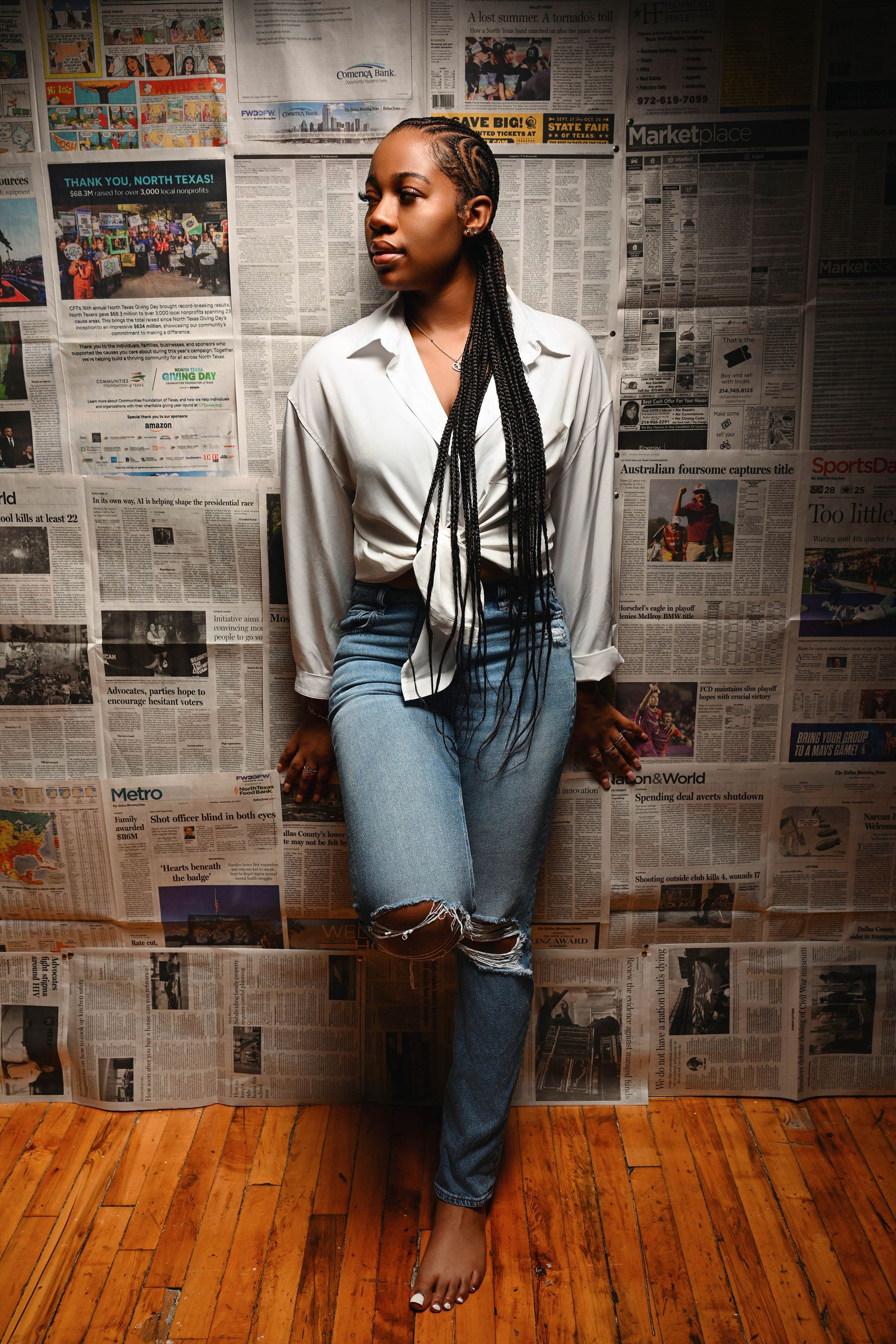 a woman in a white bra and black pants is standing on a white background .