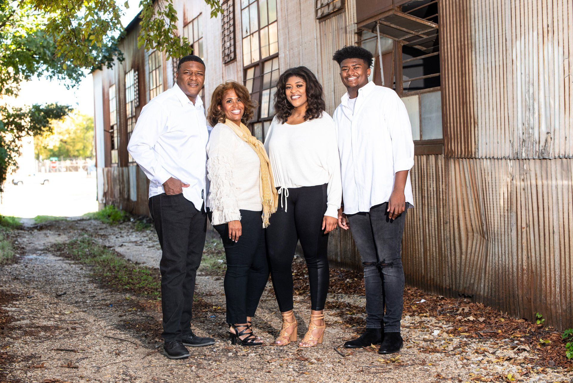 a family is posing for a picture in front of a building .