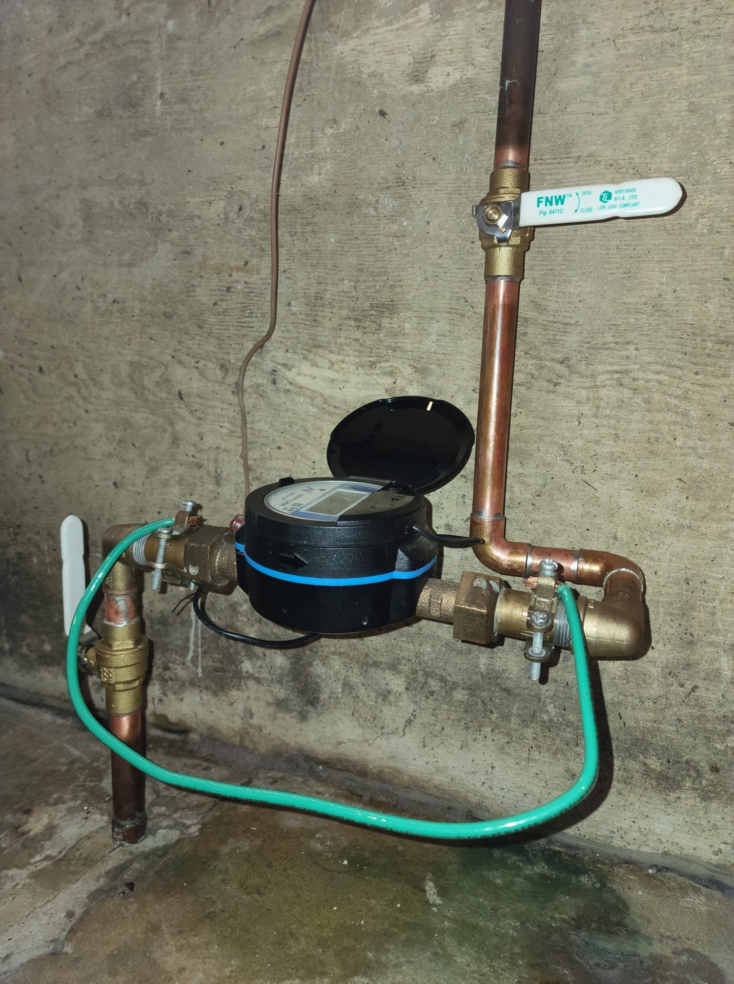 A water meter is attached to a copper pipe