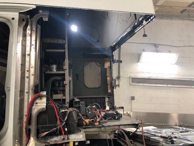 A truck is being worked on in a garage.