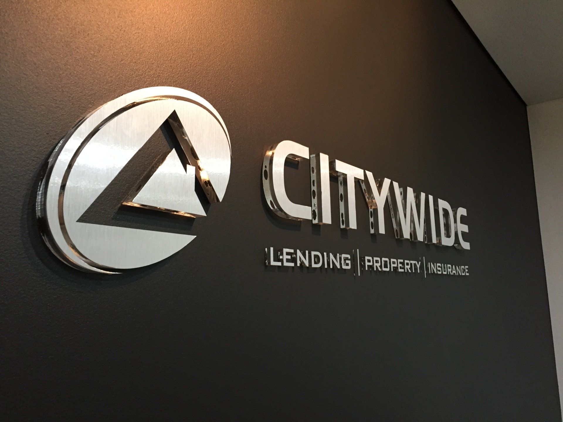 A citywide sign on a black wall