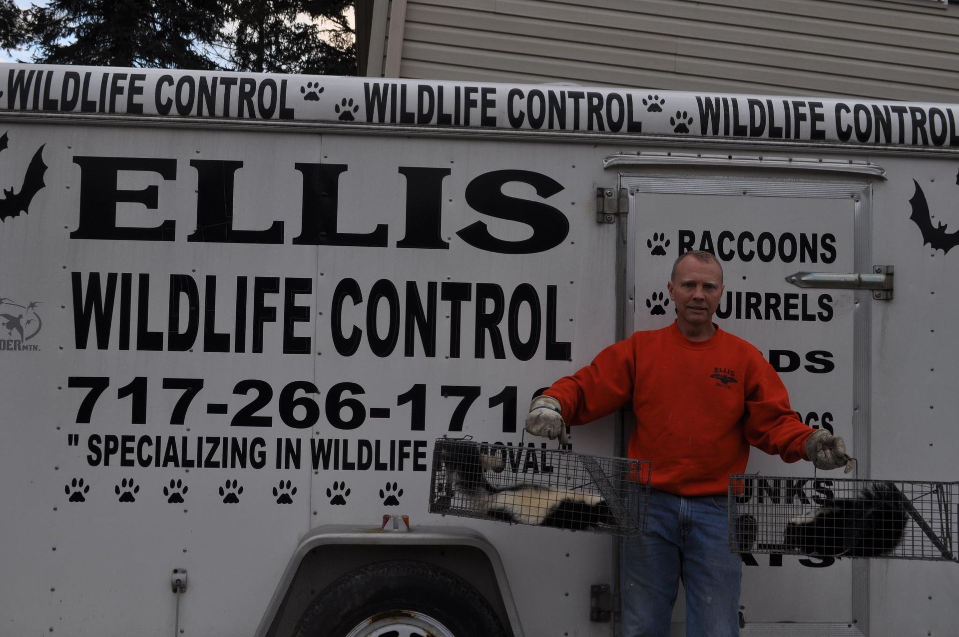 A man standing beside the trailer-  Manchester, PA - Ellis Wildlife Pest Control