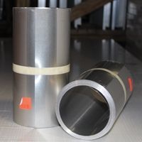 Two rolls of aluminum foil are sitting next to each other on a table.