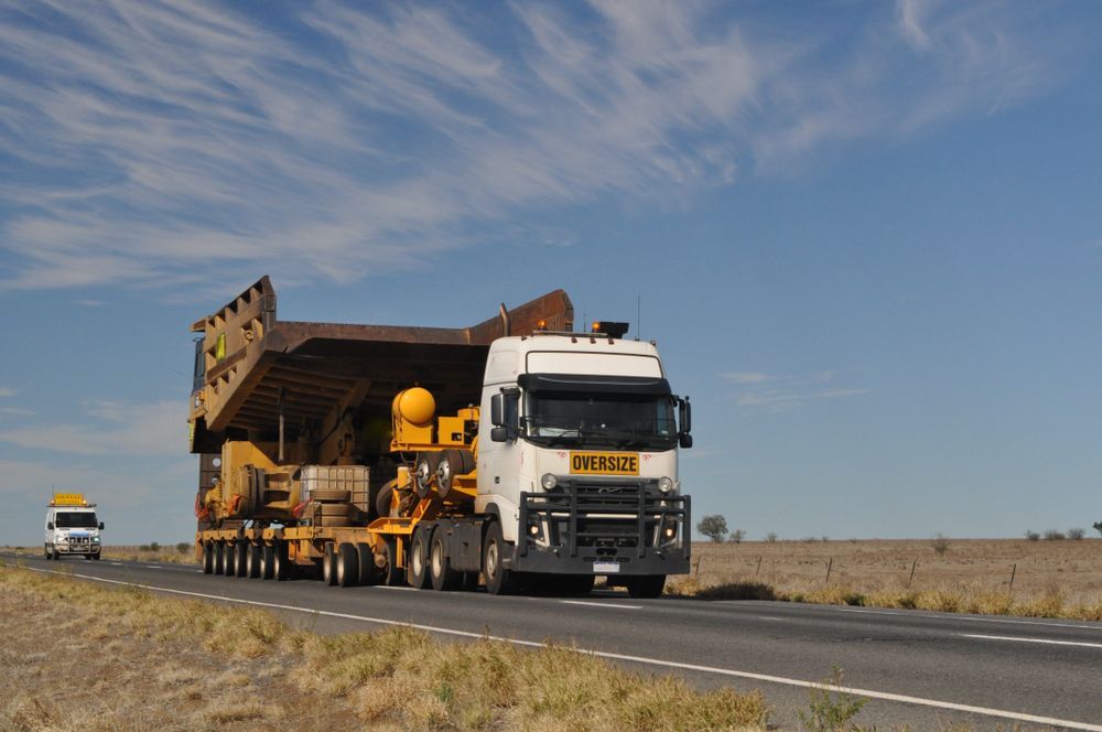 A Large Truck Hauling Oversized Machinery — Aust. Advanced Trailer Sales & Service in Coober Pedy, SA