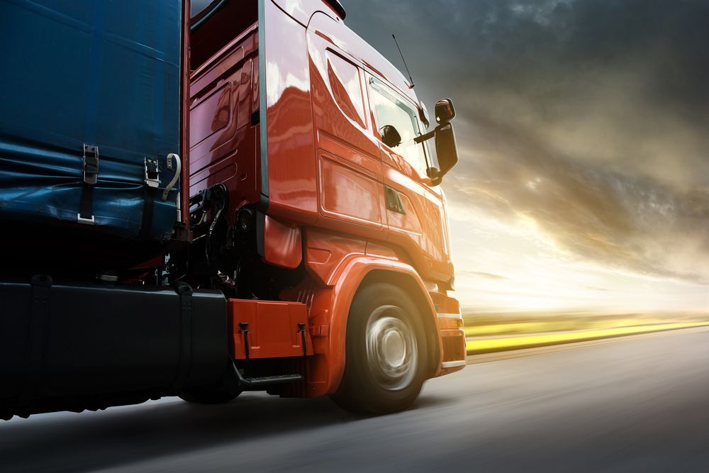 A Red Semi-Truck Driving on A Highway — Aust. Advanced Trailer Sales & Service in Berrimah, NT