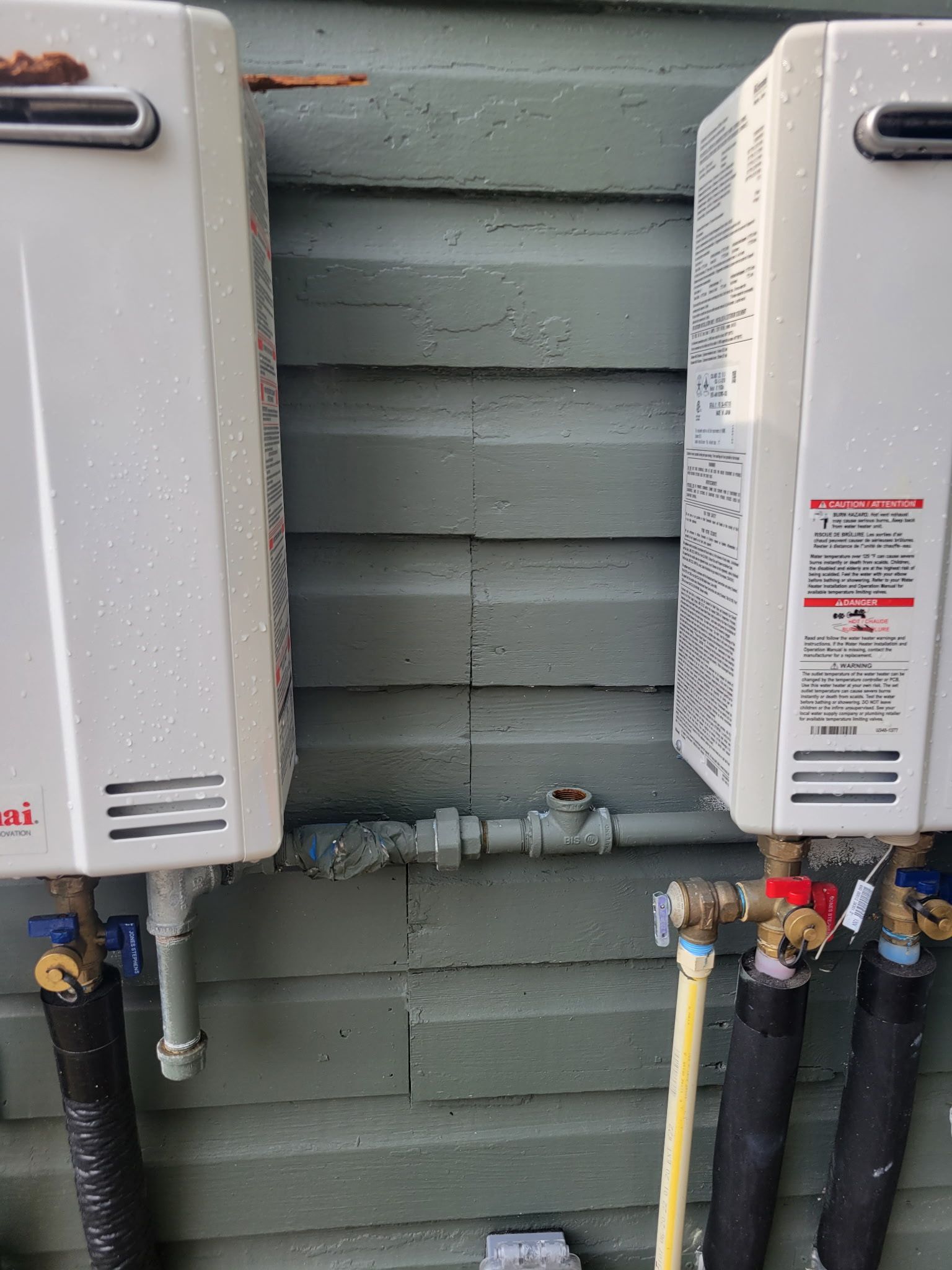 A Gro-Pro truck parked in front of a brick house with a well-manicured lawn.