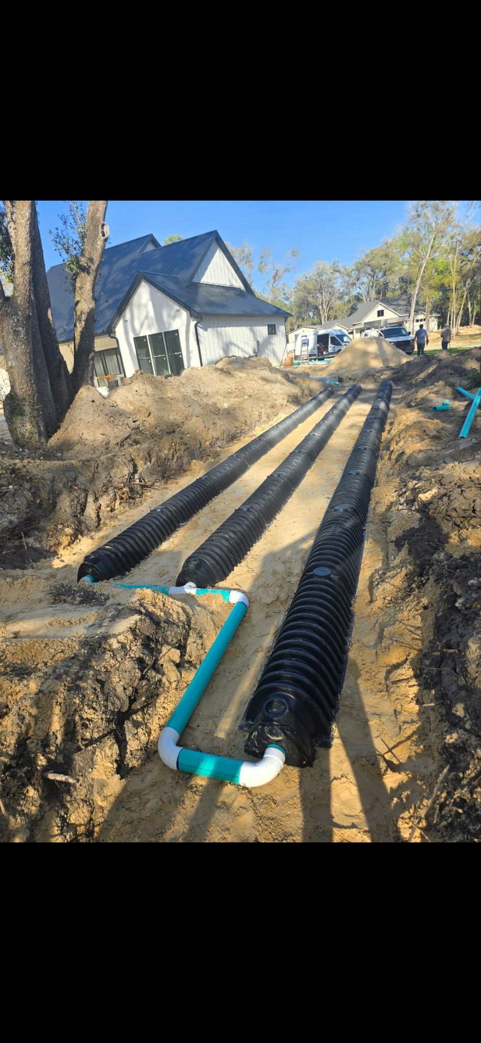 Sprinkler spraying water onto green grass, creating a misty spray against a blurred background.