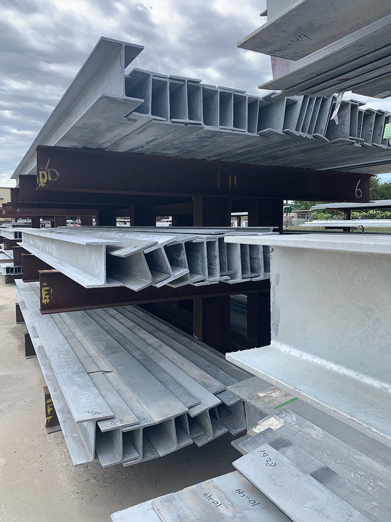 A bunch of metal beams are stacked on top of each other.