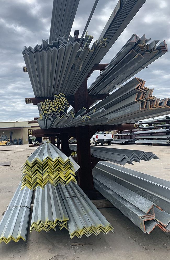A bunch of metal pieces are stacked on top of each other on a rack.