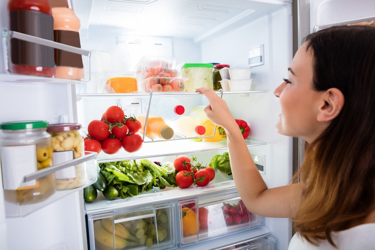 Refrigeration Repair — Woman Checking Refrigerator in Hampton Roads, VA