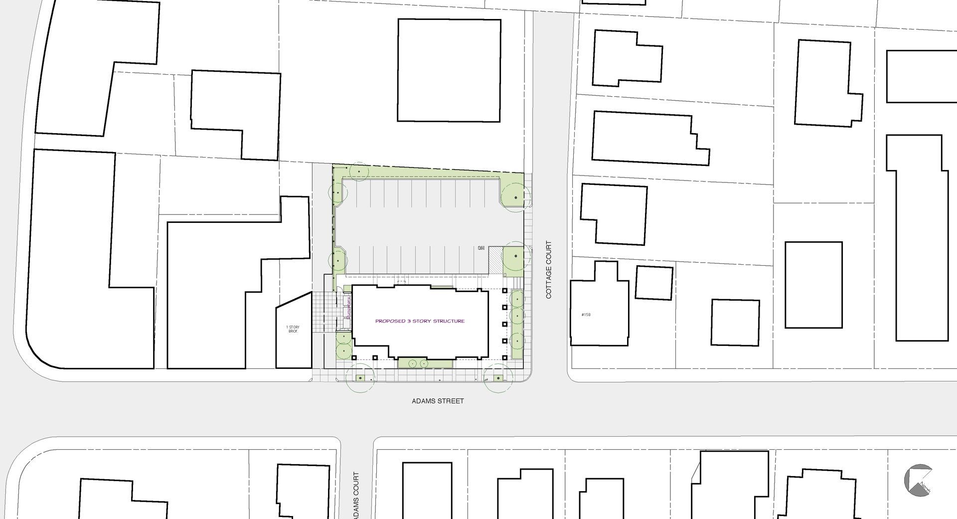 Overhead view of a building with surrounding parking and landscaping, situated among other buildings and roads in a town.
