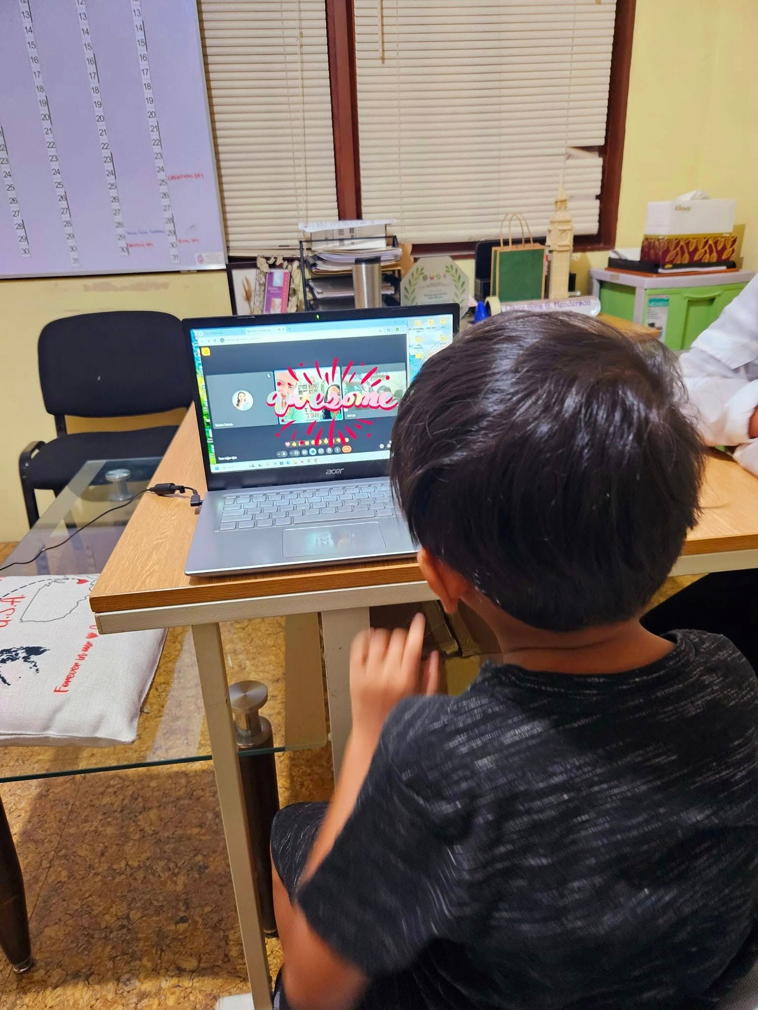 Person playing an acoustic guitar, fingers on frets. Red and green stage lighting.