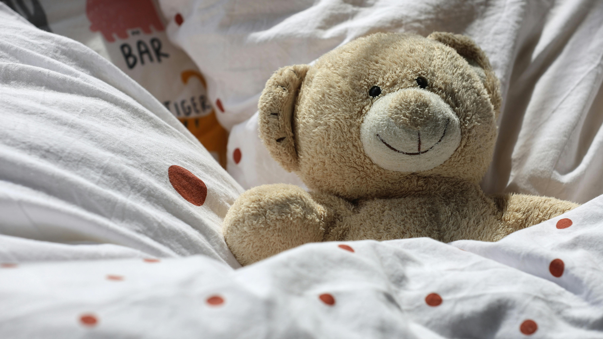 Woman with arms raised in a crowd, likely at a concert or church service with stage lights in the background.